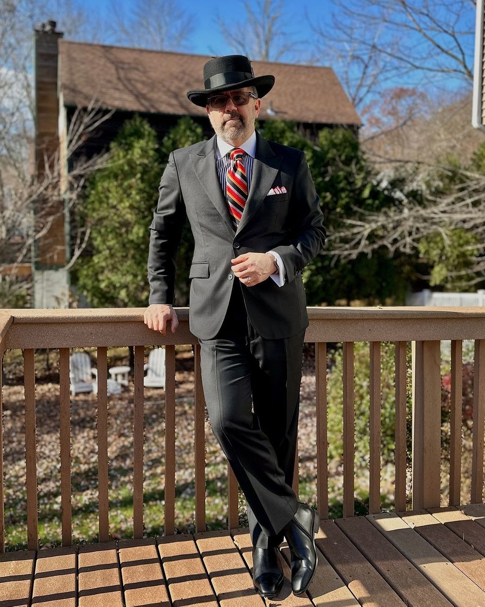 Classic Black Suit with Striped Tie and Bowler Hat