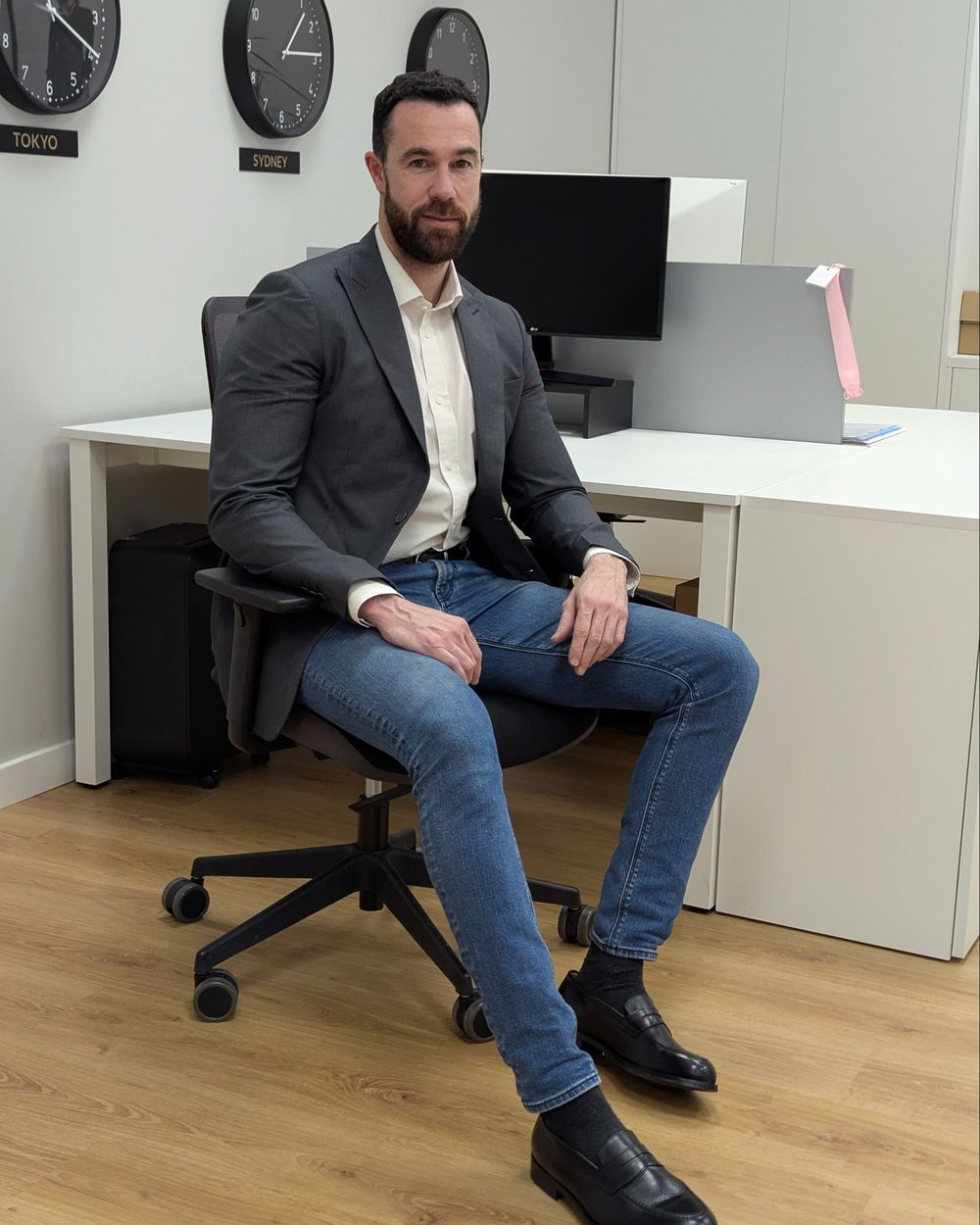 Gray Blazer with Cream Shirt and Slim Blue Jeans
