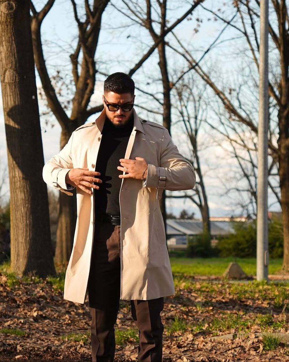 Beige Trench Coat with Black Turtleneck and Brown Trousers