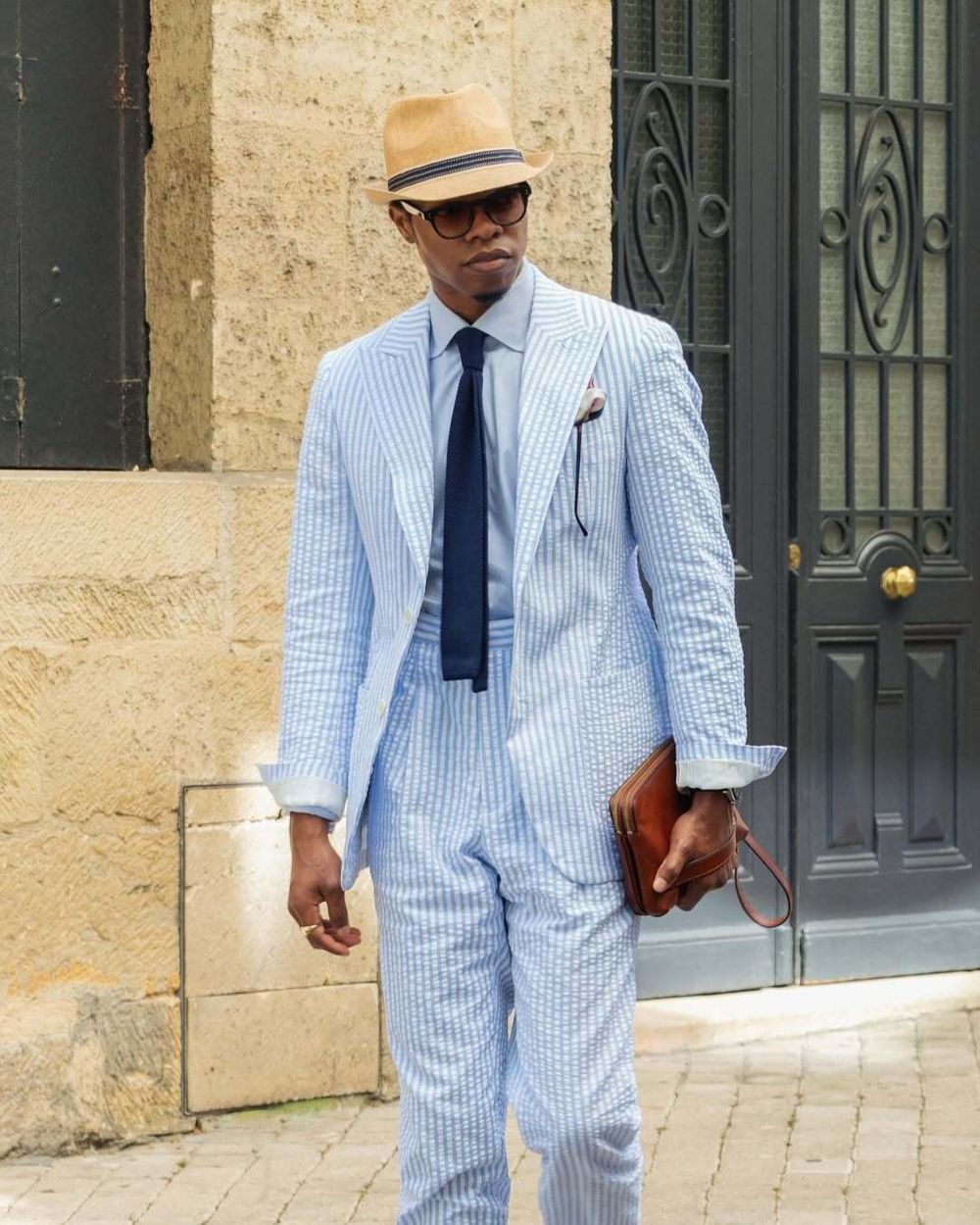 Blue and White Seersucker Suit with Navy Tie and Straw Hat