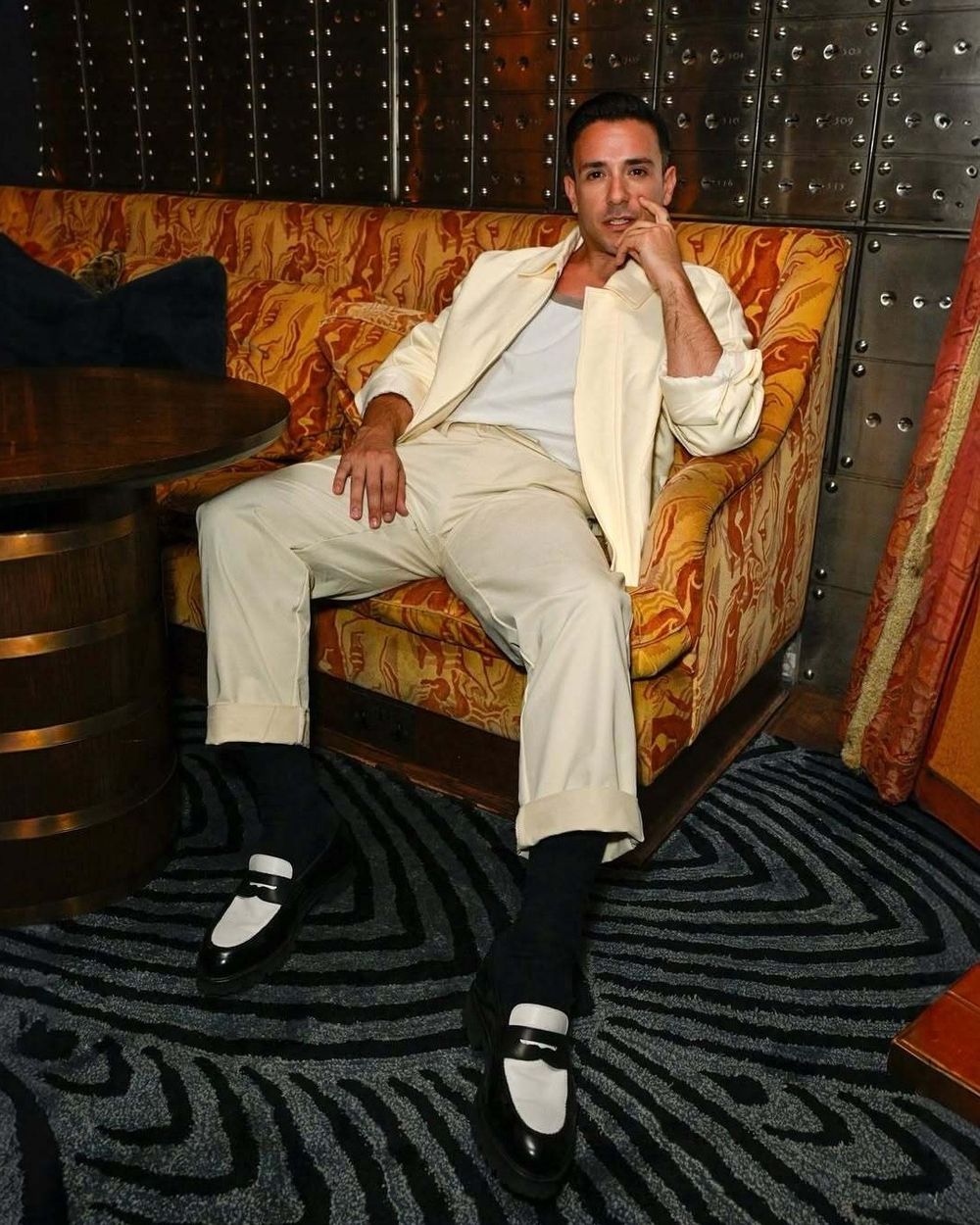 Ivory Bomber Jacket with White Tank Top and Pleated Trousers