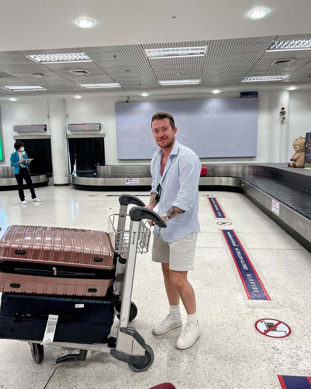 Light Blue Striped Shirt with Beige Bermuda Shorts and Sneakers