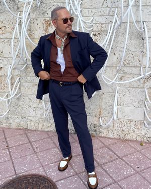 Navy Suit with Rust Shirt and White Loafers