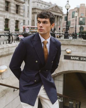 navy-pinstripe-blazer-white-trousers-yellow-tie