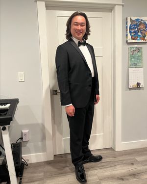 Classic Black Tuxedo with Bow Tie and Patent Leather Shoes