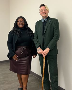 forest-green-suit-black-shirt-floral-bow-tie