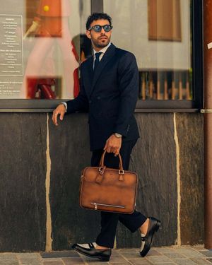 Navy Pinstriped Suit with Black Tie and Brown Leather Briefcase