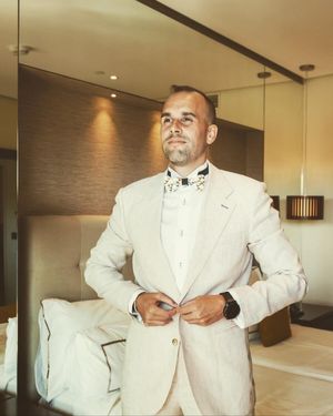 beige-linen-suit-white-dress-shirt-bow-tie