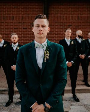 green-suit-for-the-groom-black-for-the-groomsmen
