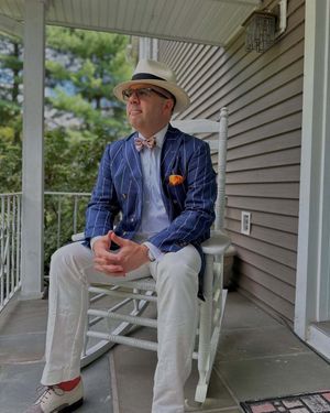 Blue Pinstriped Blazer with White Trousers and Hat
