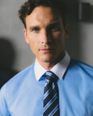 Blue Button-Up Shirt with White Collar and Striped Tie