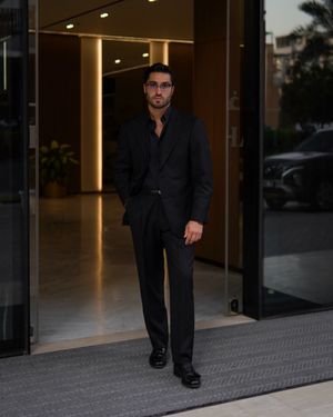 all-black-tailored-suit-open-collar-shirt