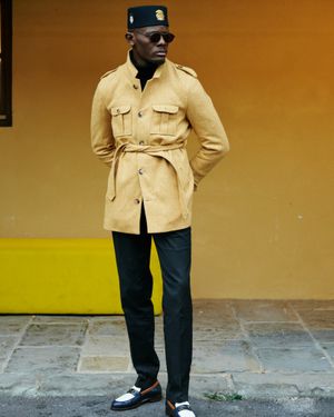 Mustard Belted Safari Jacket with Black Turtleneck and Black Trousers